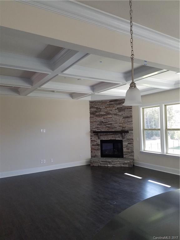 7003 Fallondale Road, Unit MB515 Waxhaw, NC 28173 - Photo 4 of 10 a view of an empty room with wooden floor fireplace and a window