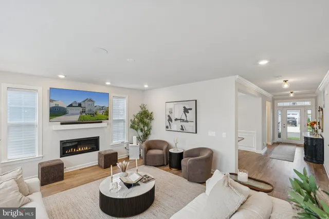 a kitchen with stainless steel appliances kitchen island granite countertop a dining table chairs refrigerator and sink