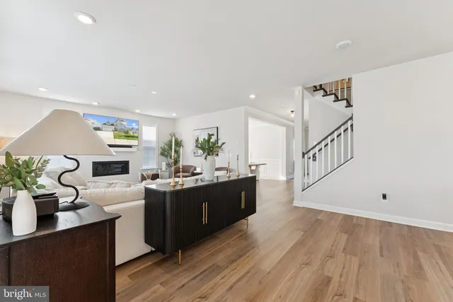a dining room filled chandelier and wooden floor