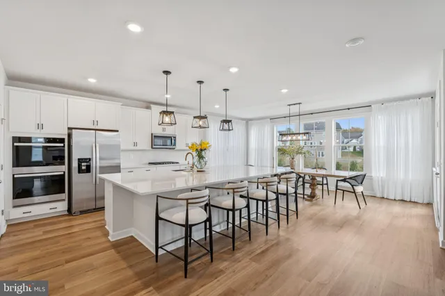 a dining room with furniture entryway and wooden floor