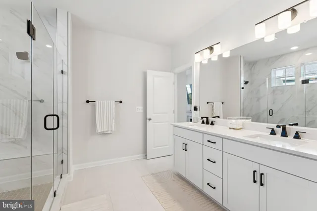 a front view of a building with a yard and trees