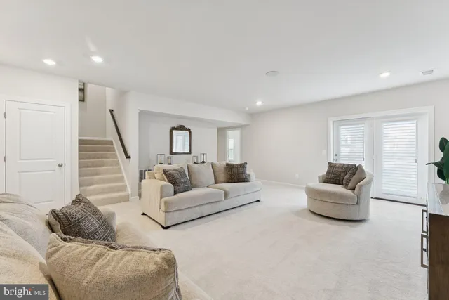 a front view of a house with a yard and a large tree