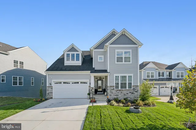 a view of a white house next to a yard and a yard