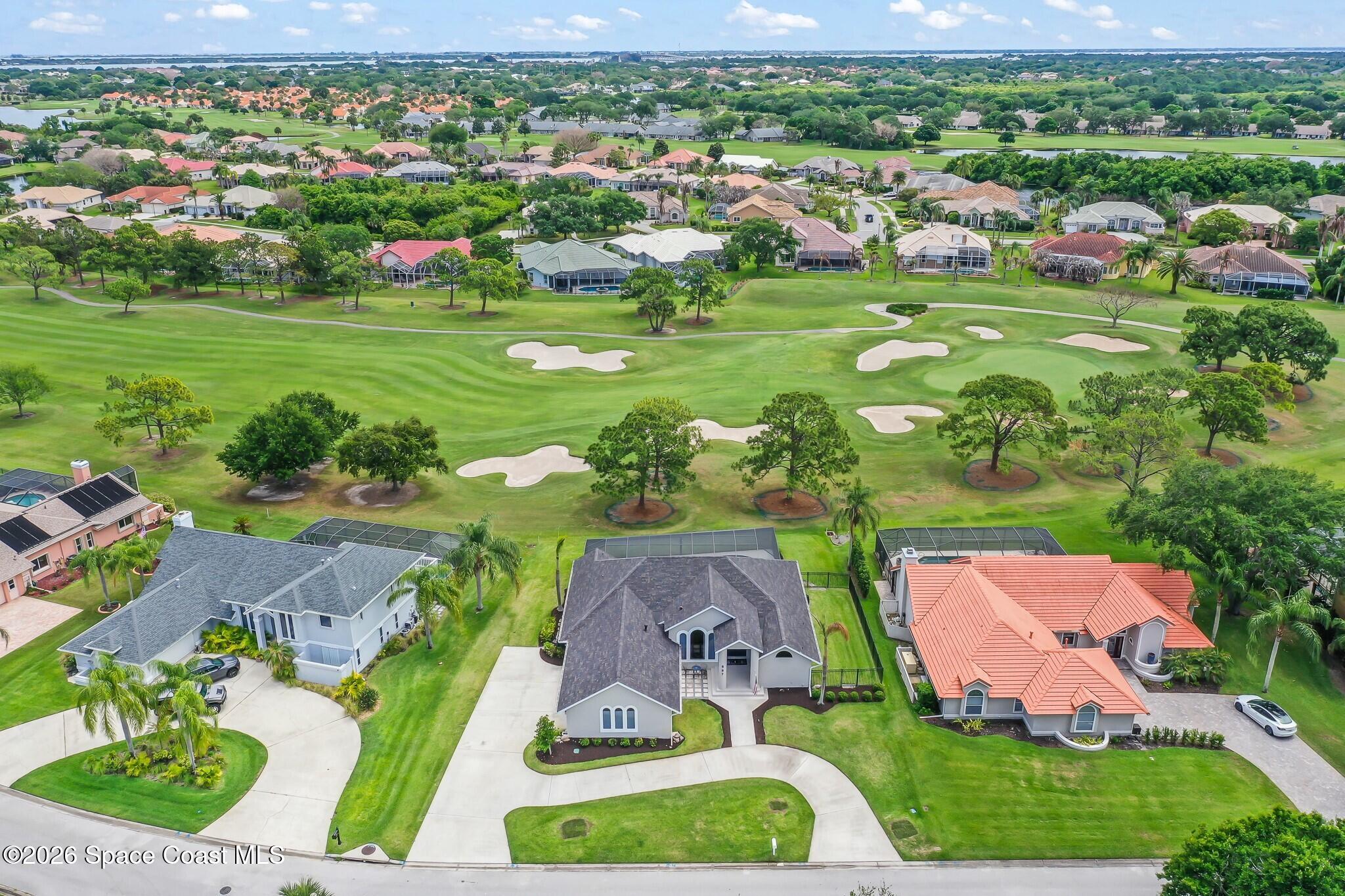 697 Spring Lake Drive Melbourne, FL 32940 - Photo 5 of 45 an aerial view of residential houses with outdoor space and street view