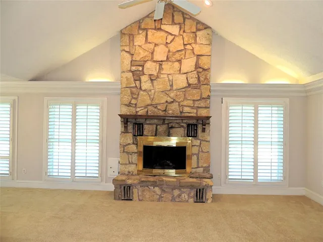 a living room with fireplace and a flat screen tv