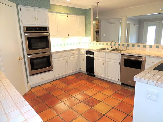 a kitchen with a stove sink and a microwave