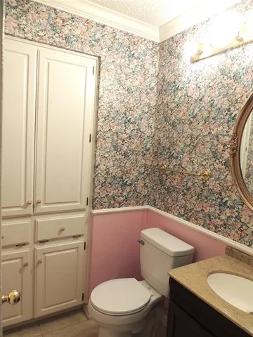 a white toilet sitting next to a shower curtain