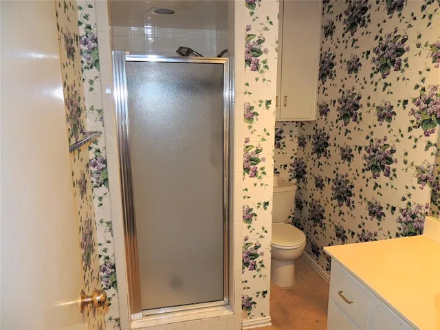 view of a bathroom with a toilet and a shower curtain