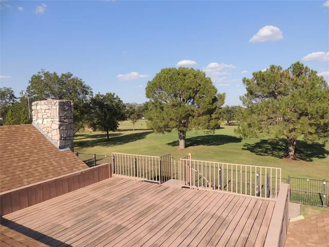 a view of a balcony with wooden floor