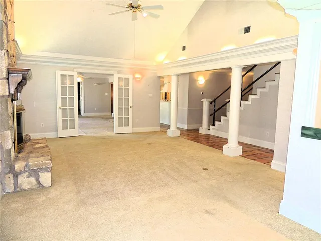 a view of a livingroom with wooden floor and furniture