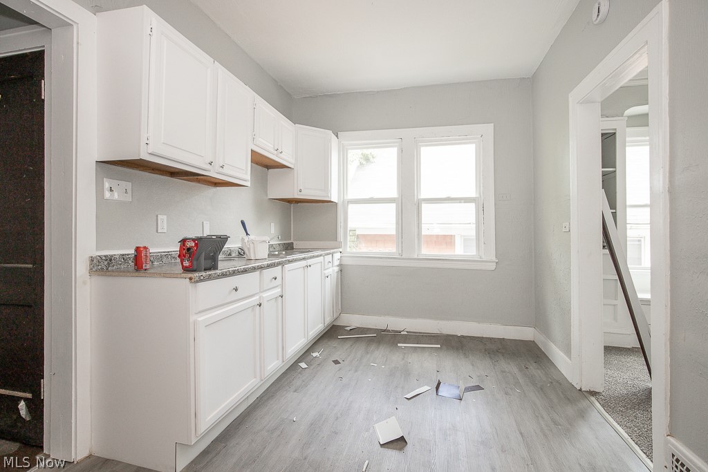 1000 Eddy Road Cleveland, OH 44108 - Photo 28 of 38 Kitchen featuring white cabinets, light countertops, and light wood-type flooring