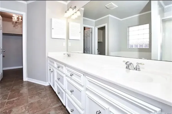 a bathroom with a sink double vanity and a mirror