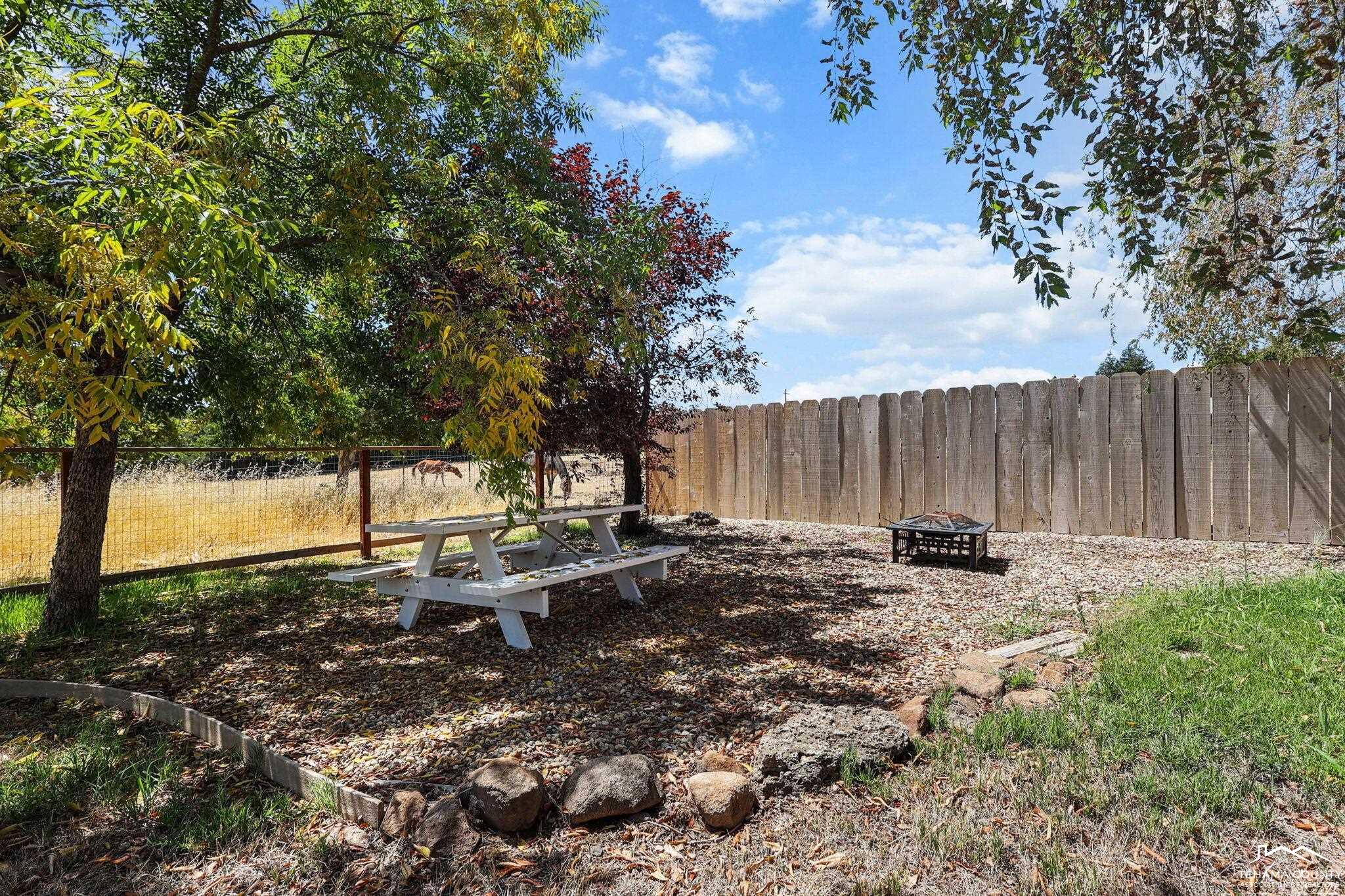22275 Brent Road Red Bluff, CA 96080 - Photo 30 of 47 a backyard of a house with table and chairs