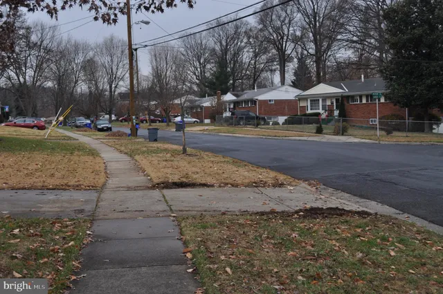 a view of a street with houses on both side of the street