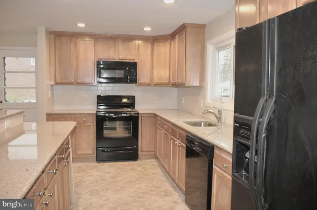 a kitchen with a sink a stove and refrigerator