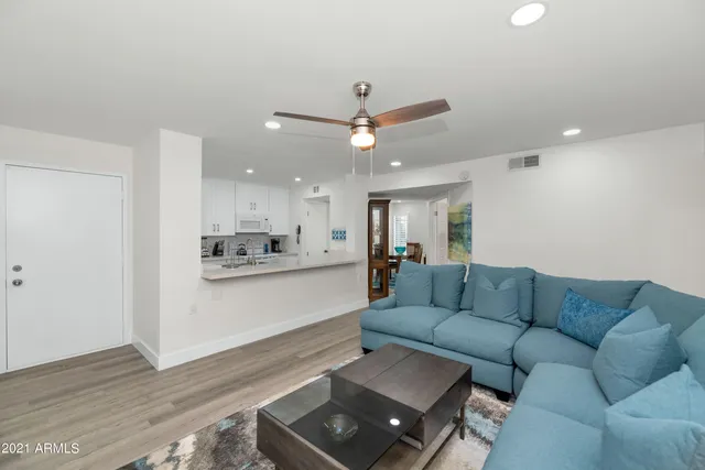 a living room with furniture and a wooden floor