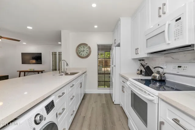a kitchen with a sink a stove and cabinets