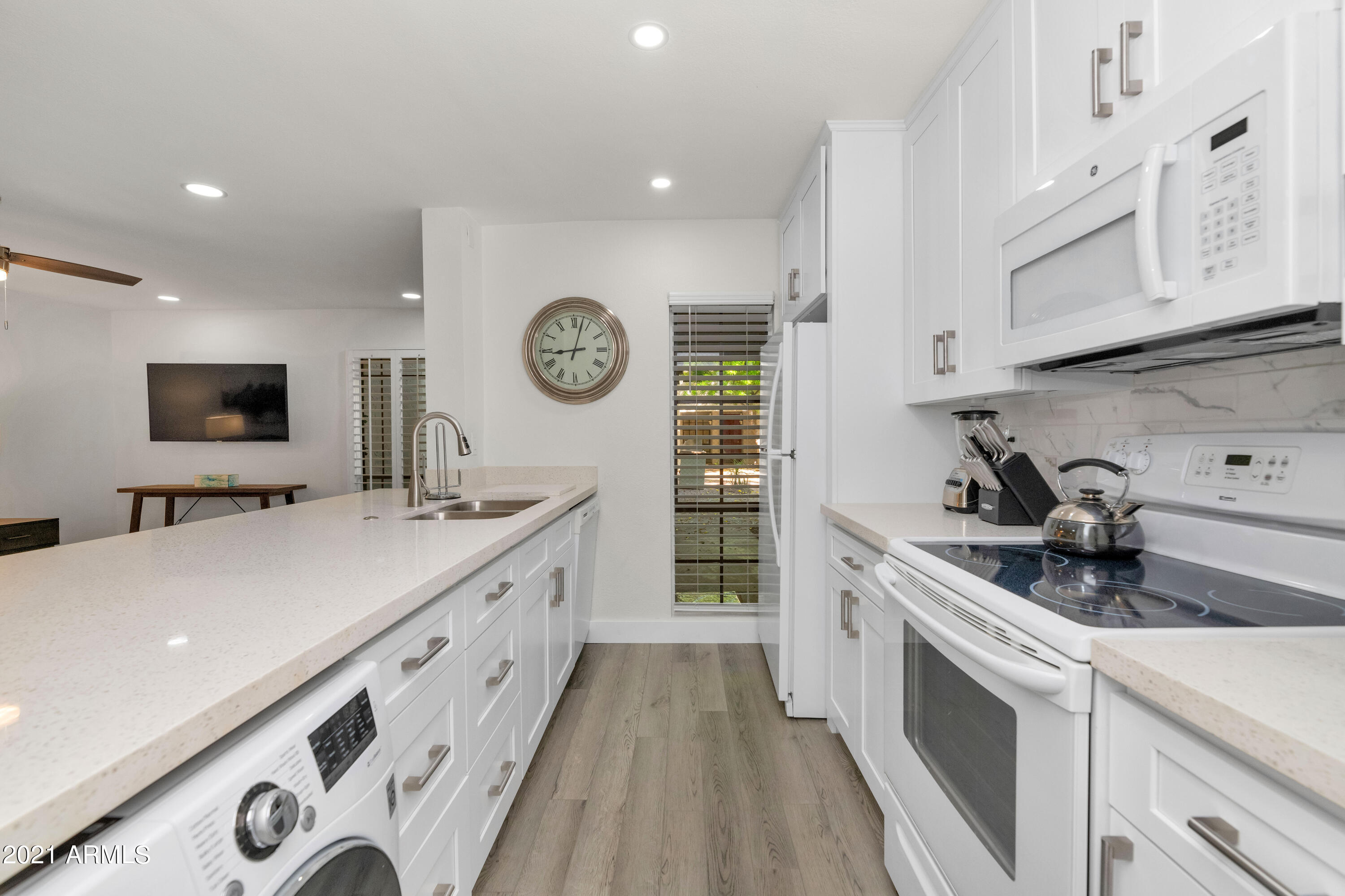 5221 North 24th Street, Unit 106 Phoenix, AZ 85016 - Photo 5 of 20 a kitchen with a sink a stove and cabinets