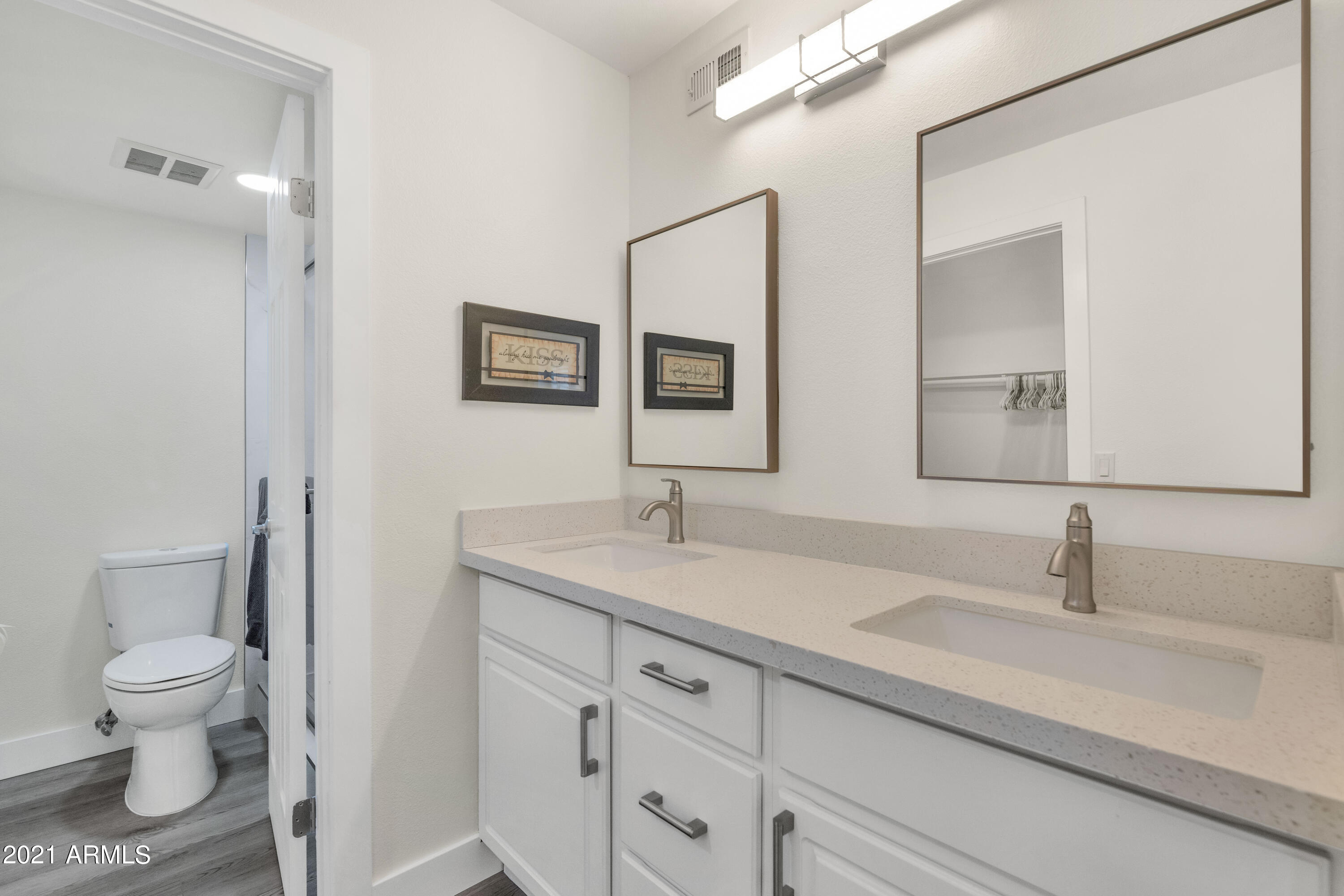 5221 North 24th Street, Unit 106 Phoenix, AZ 85016 - Photo 10 of 20 a bathroom with a toilet a sink and mirror