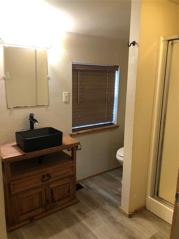 210 Jones Road Graford, TX 76449 - Photo 18 of 25 a room with a chair and a mirror