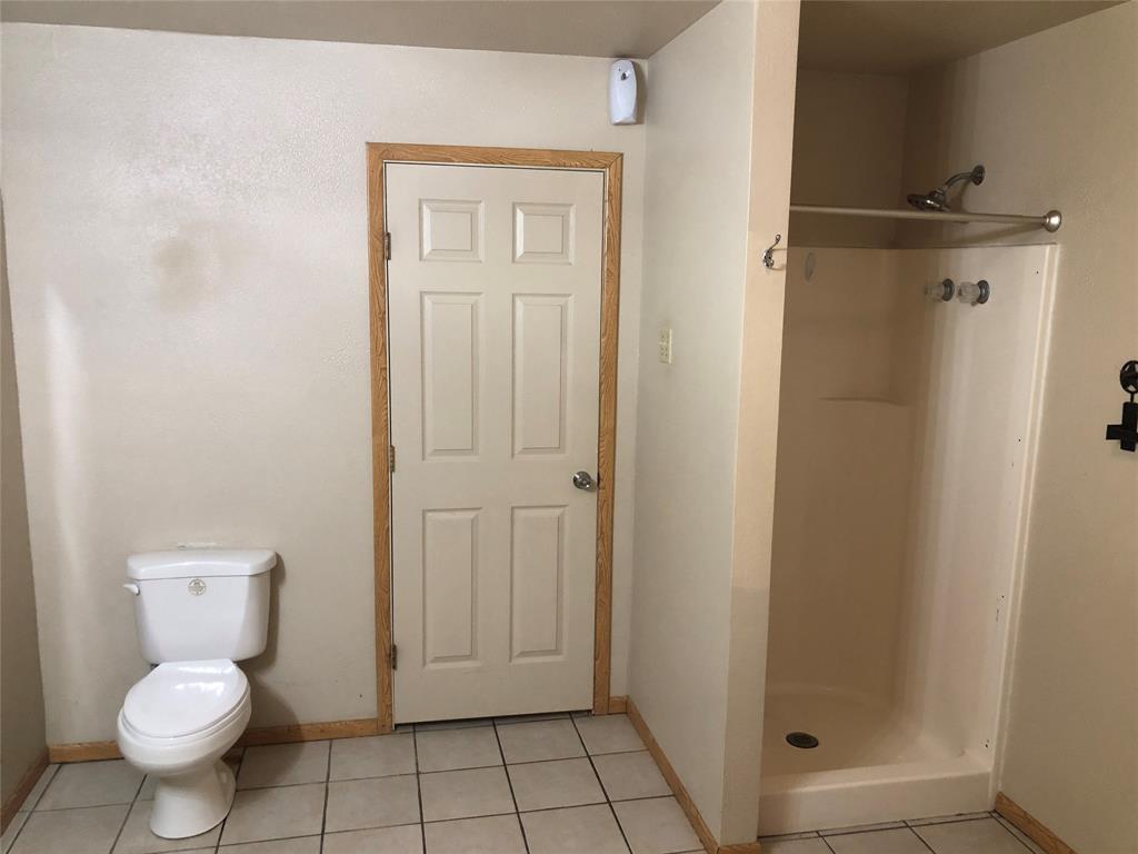 210 Jones Road Graford, TX 76449 - Photo 10 of 25 a bathroom with a toilet