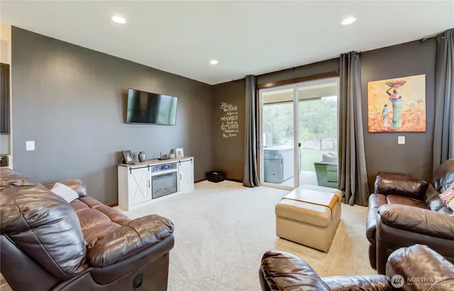 a bedroom with furniture and a flat screen tv