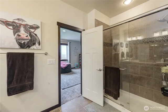 a bathroom with a mirror and a shower