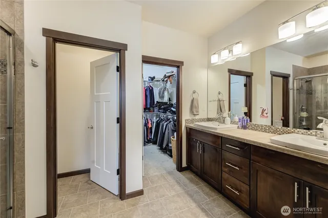 a en suite bathroom with a double vanity sink double and mirror