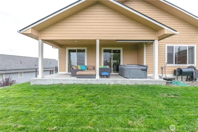 a view of a house with a backyard patio and swimming pool