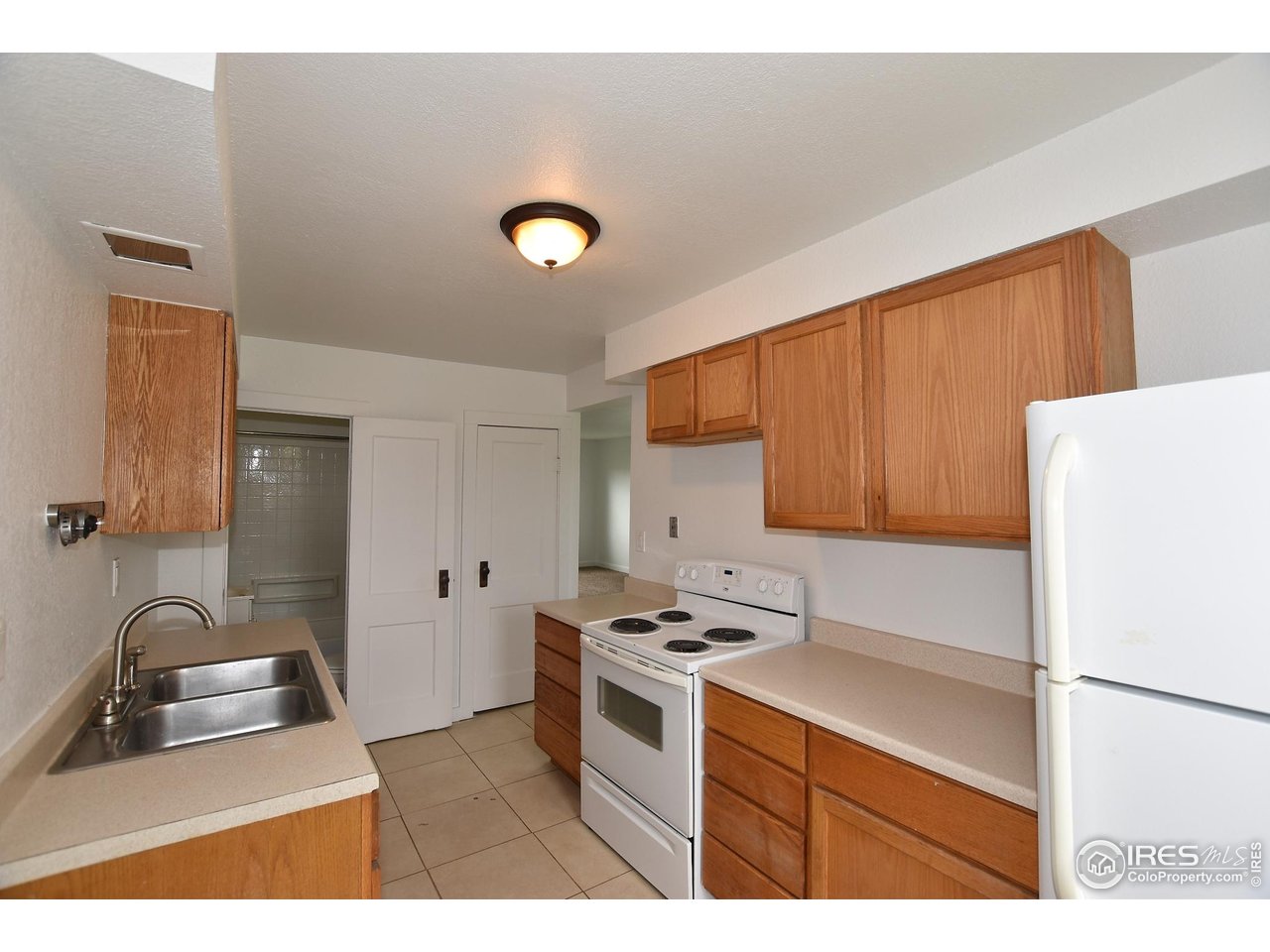 1340 North Taft Hill Road Fort Collins, CO 80521 - Photo 35 of 40 a kitchen with a refrigerator sink and stove