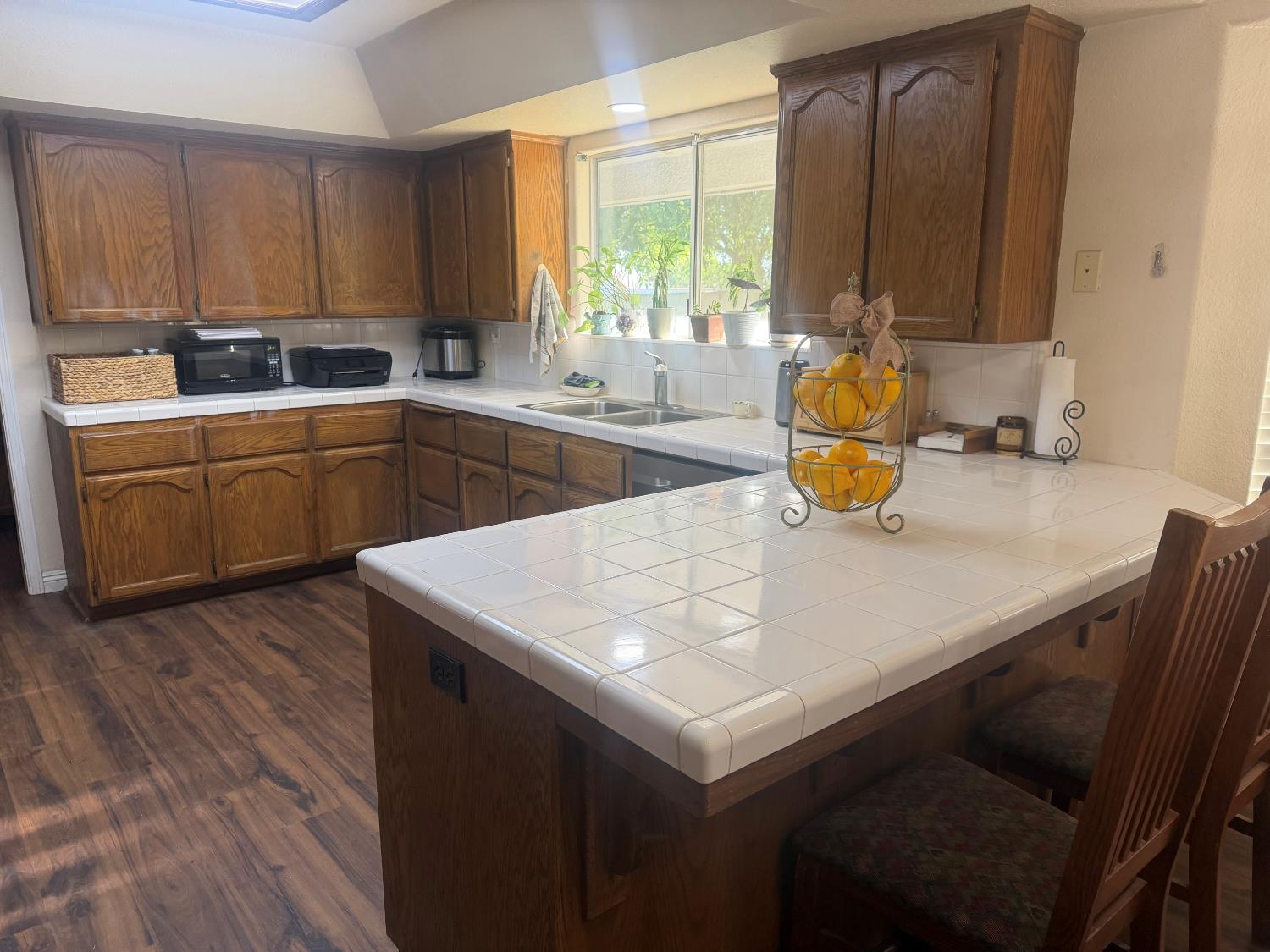 16638 Mark Road Madera, CA 93636 - Photo 10 of 22 a kitchen with a sink a window and appliances