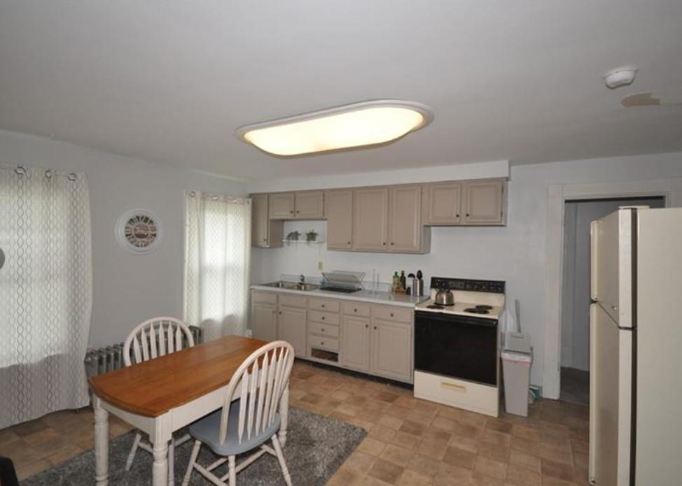 626-628 Pittsburgh Street Springdale, PA 15144 - Photo 34 of 34 a kitchen with stainless steel appliances granite countertop a kitchen island hardwood floor sink stove dining table and chairs