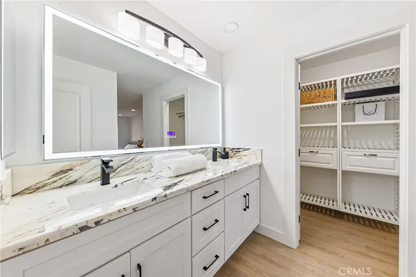 a bathroom with a granite countertop sink and a mirror