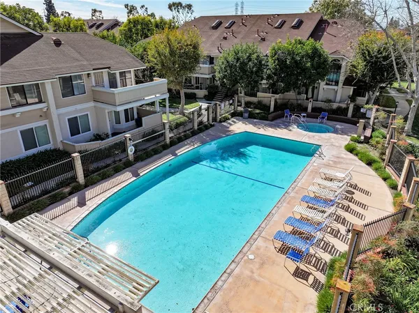 an aerial view of a house with swimming pool garden and patio