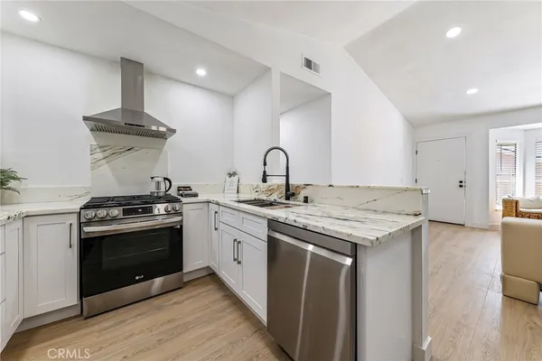 a kitchen with a stove and a sink