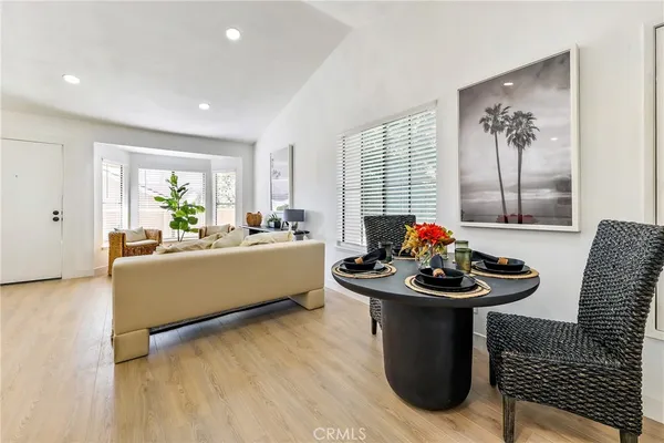a living room with furniture and a large mirror