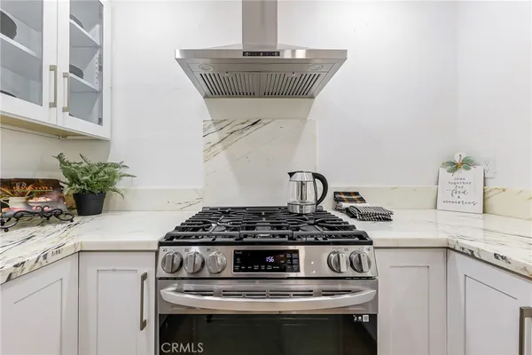 a kitchen with a stove and cabinets