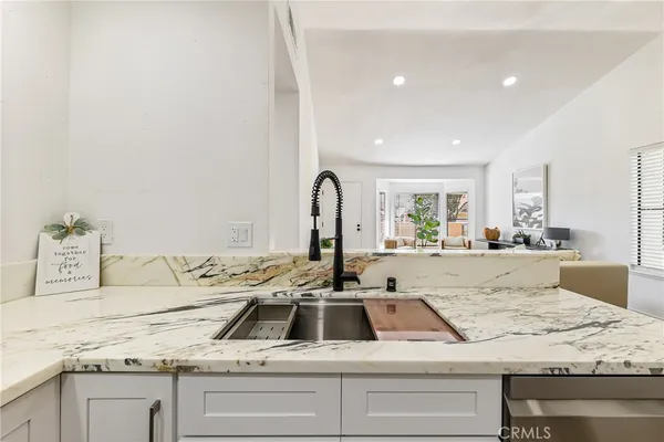a view of a kitchen counter top a sink and appliances
