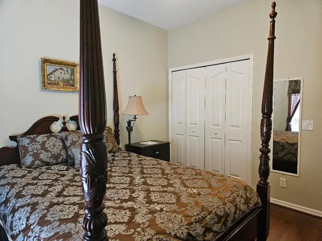 a bed sitting in a bedroom next to a window