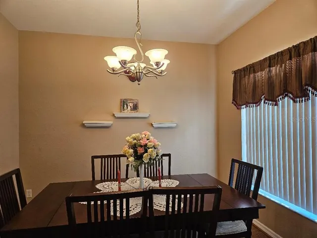 a view of a dining room with furniture wooden floor and a chandelier