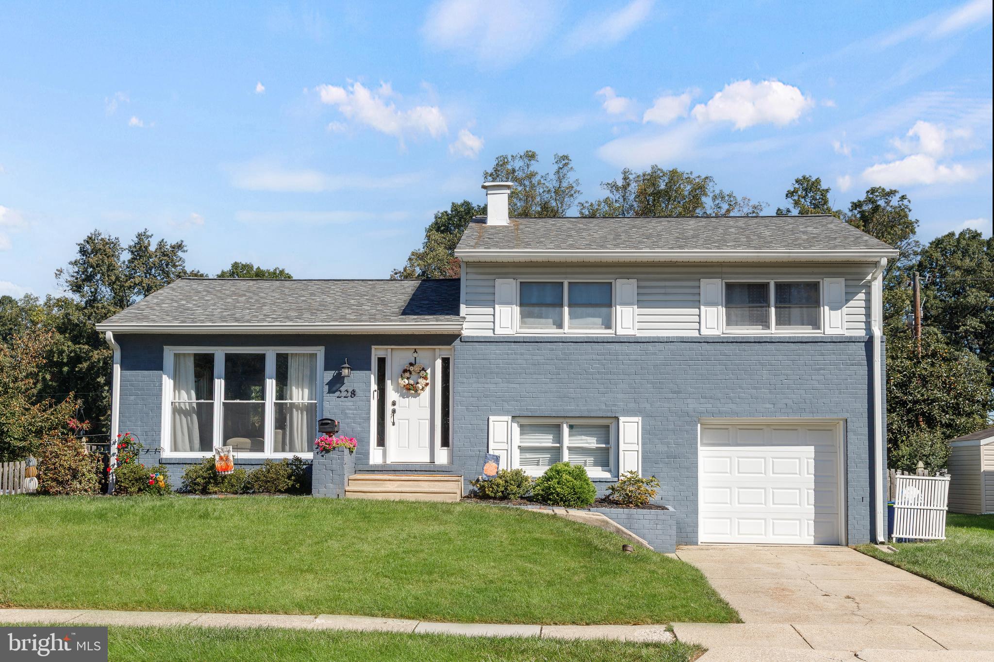 228 Quaker Ridge Road Lutherville-Timonium, MD 21093 - Photo 1 of 26 a front view of a house with a yard