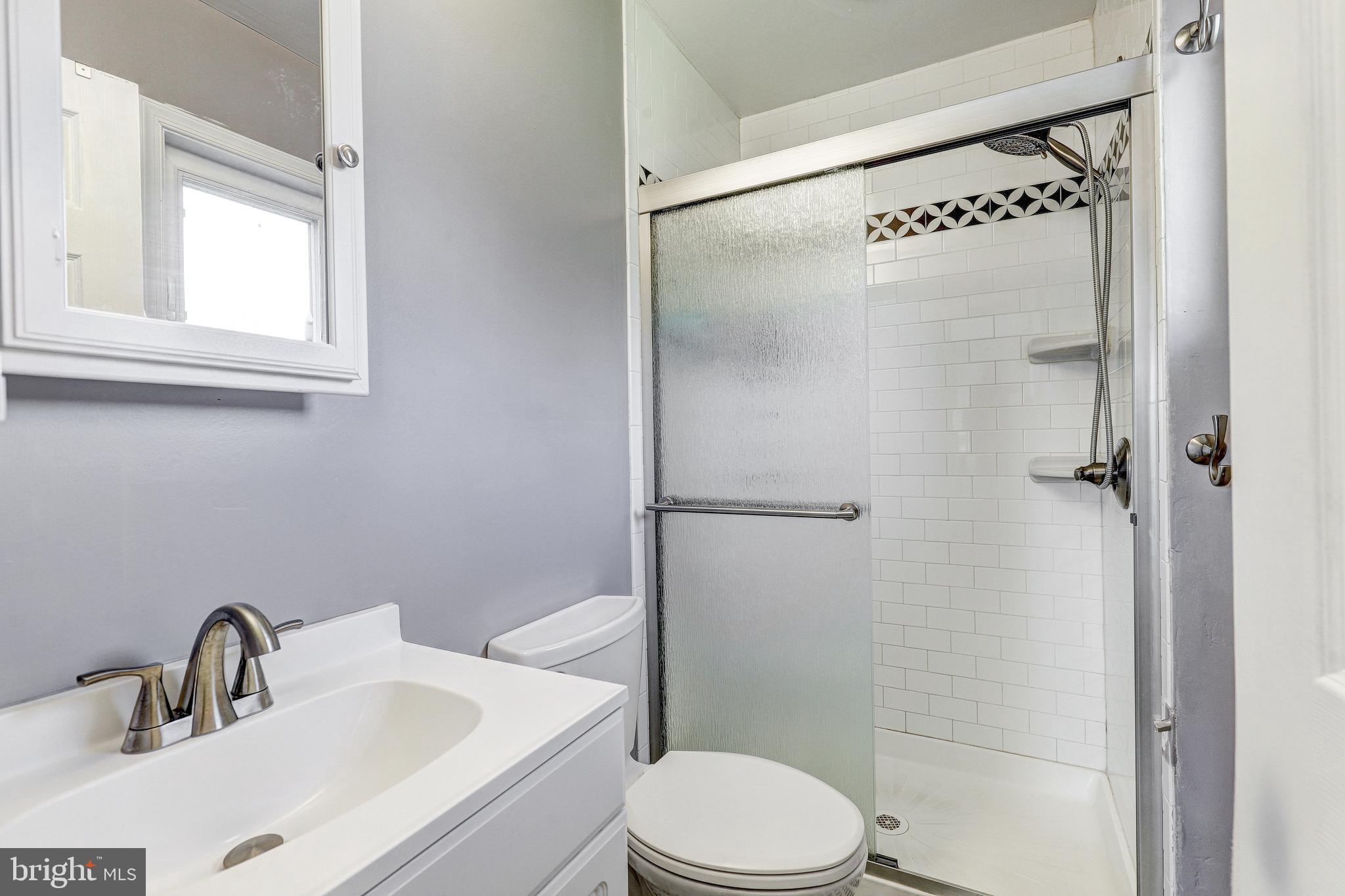 228 Quaker Ridge Road Lutherville-Timonium, MD 21093 - Photo 13 of 26 a bathroom with a sink a toilet and shower