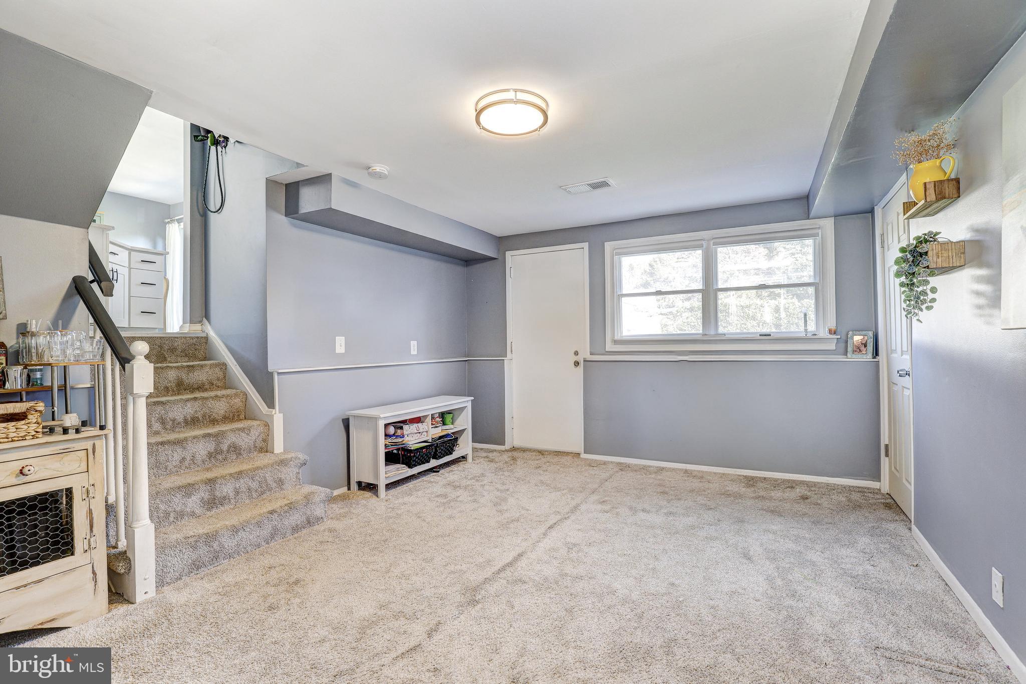 228 Quaker Ridge Road Lutherville-Timonium, MD 21093 - Photo 14 of 26 an empty room with windows and flowerpot