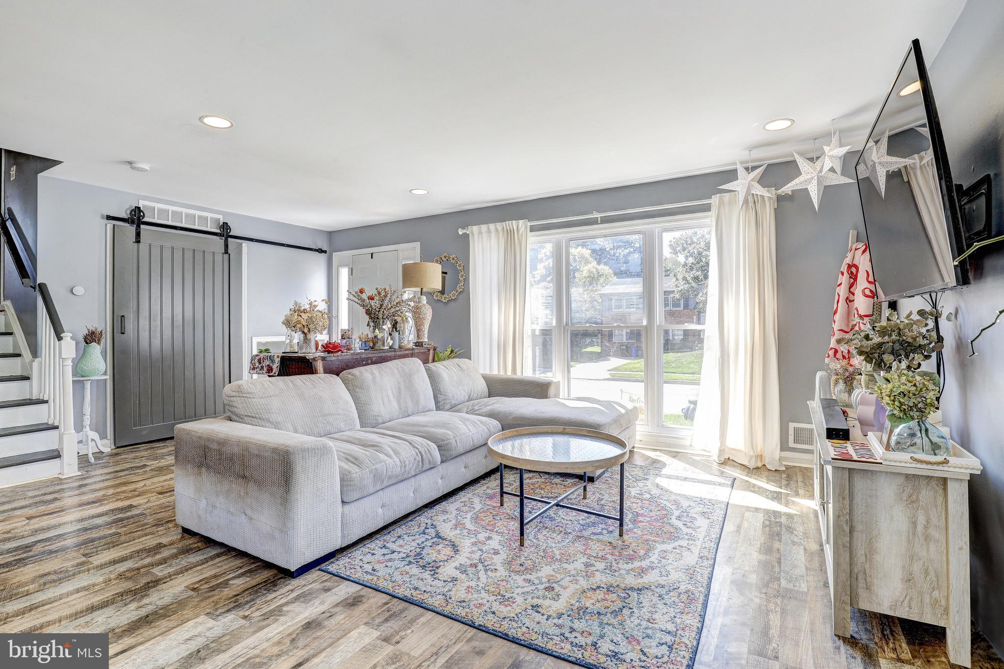 228 Quaker Ridge Road Lutherville-Timonium, MD 21093 - Photo 3 of 26 a living room with furniture and a flat screen tv