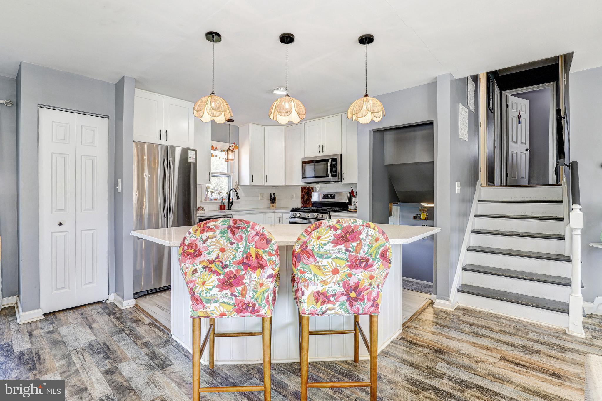 228 Quaker Ridge Road Lutherville-Timonium, MD 21093 - Photo 7 of 26 a kitchen view with stainless steel appliances granite countertop furniture a fireplace and kitchen view
