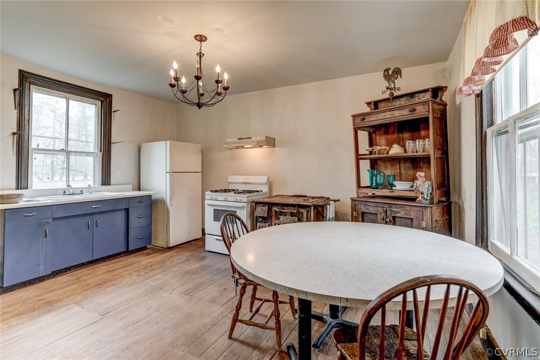 4625 Walton Road Louisa, VA 23093 - Photo 16 of 50 a kitchen with stainless steel appliances a dining table chairs and stove
