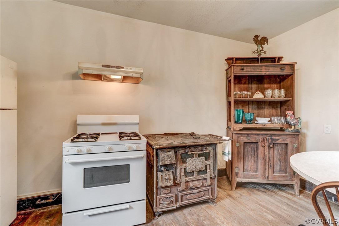 4625 Walton Road Louisa, VA 23093 - Photo 19 of 50 a kitchen with a stove and a wooden floor