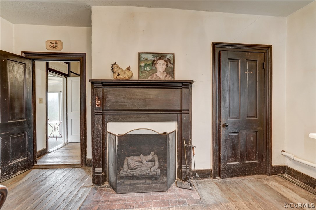 4625 Walton Road Louisa, VA 23093 - Photo 24 of 50 a hallway with fireplace and wooden floor