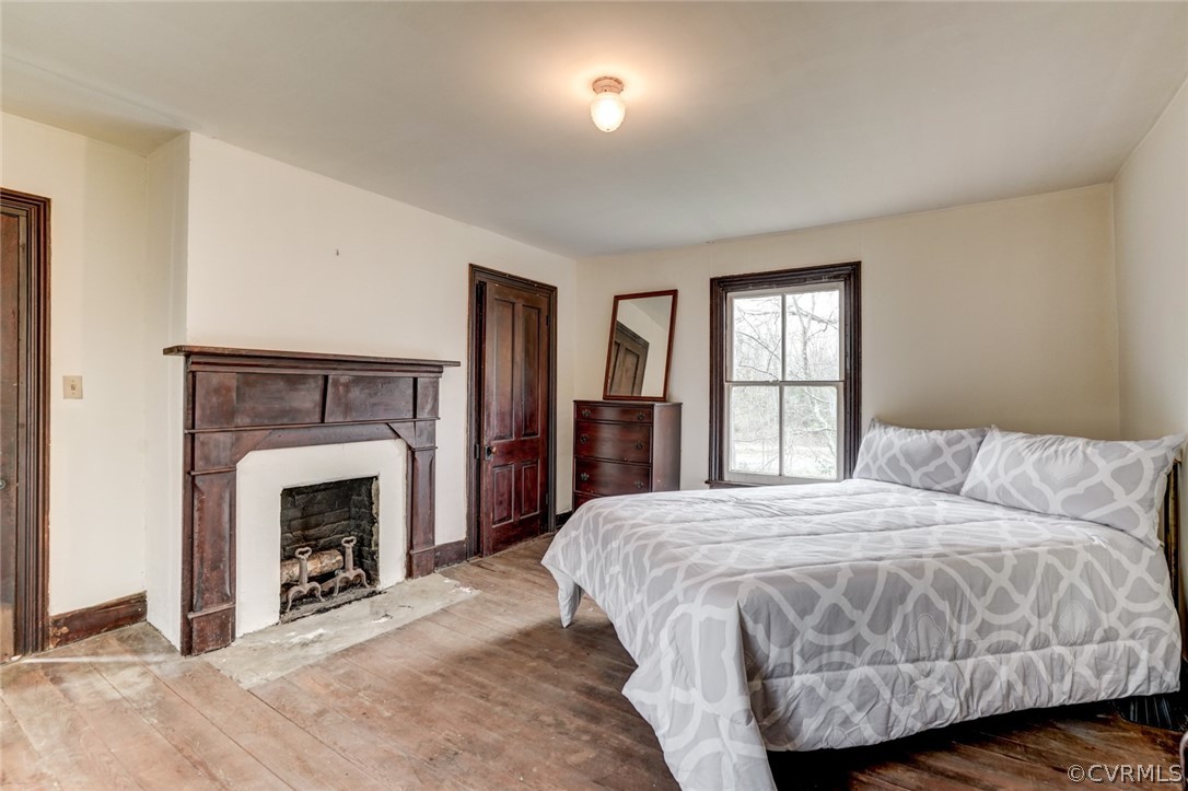 4625 Walton Road Louisa, VA 23093 - Photo 31 of 50 a bedroom with a bed and a fireplace