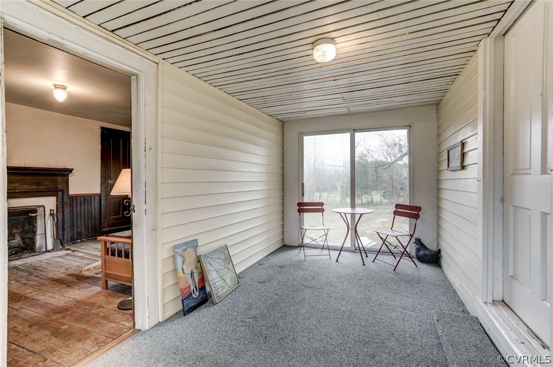 4625 Walton Road Louisa, VA 23093 - Photo 36 of 50 a view of a porch with a table and chairs and floor to ceiling window